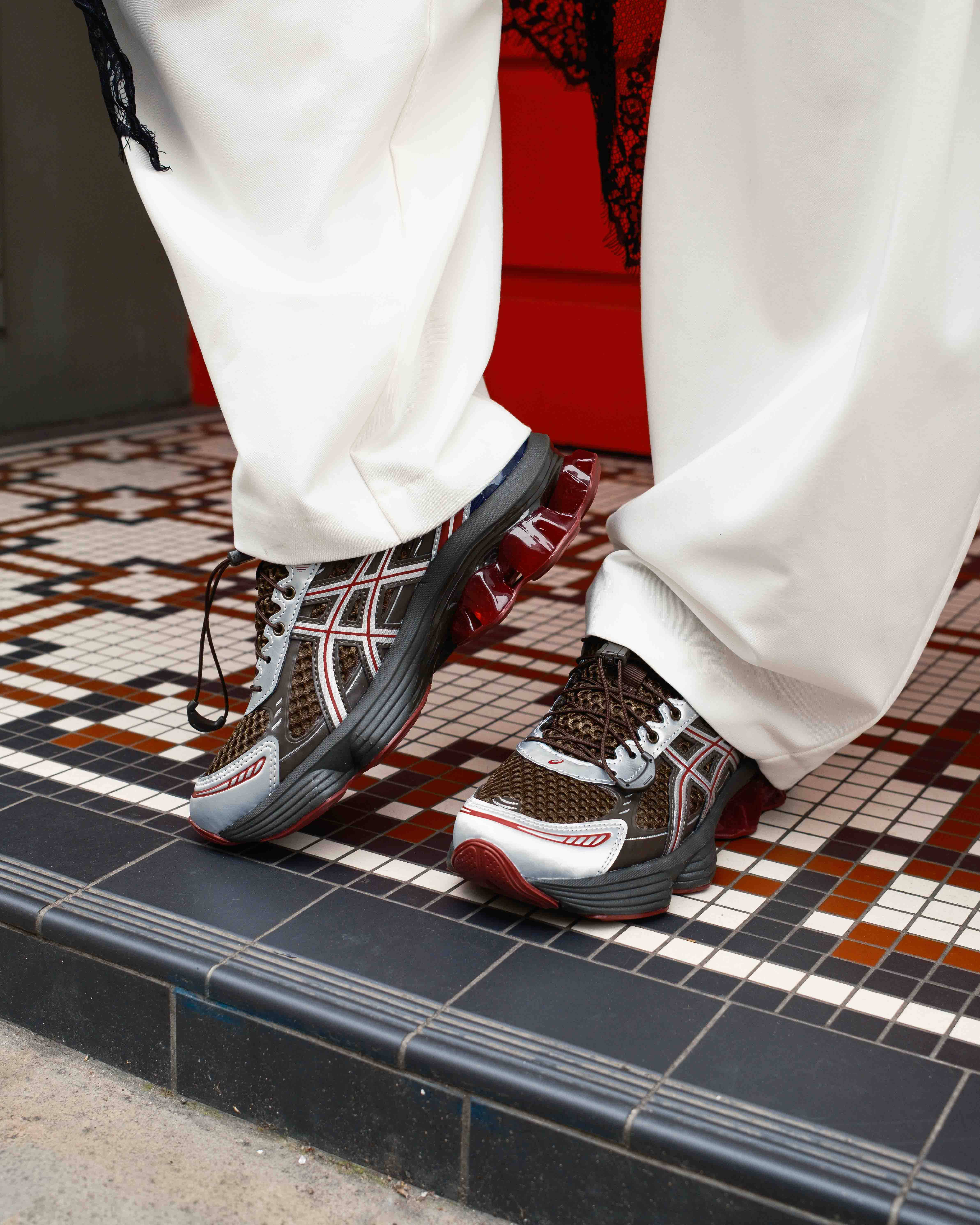 asics gel-kinetic on feet shots with mosaic floor backdrop