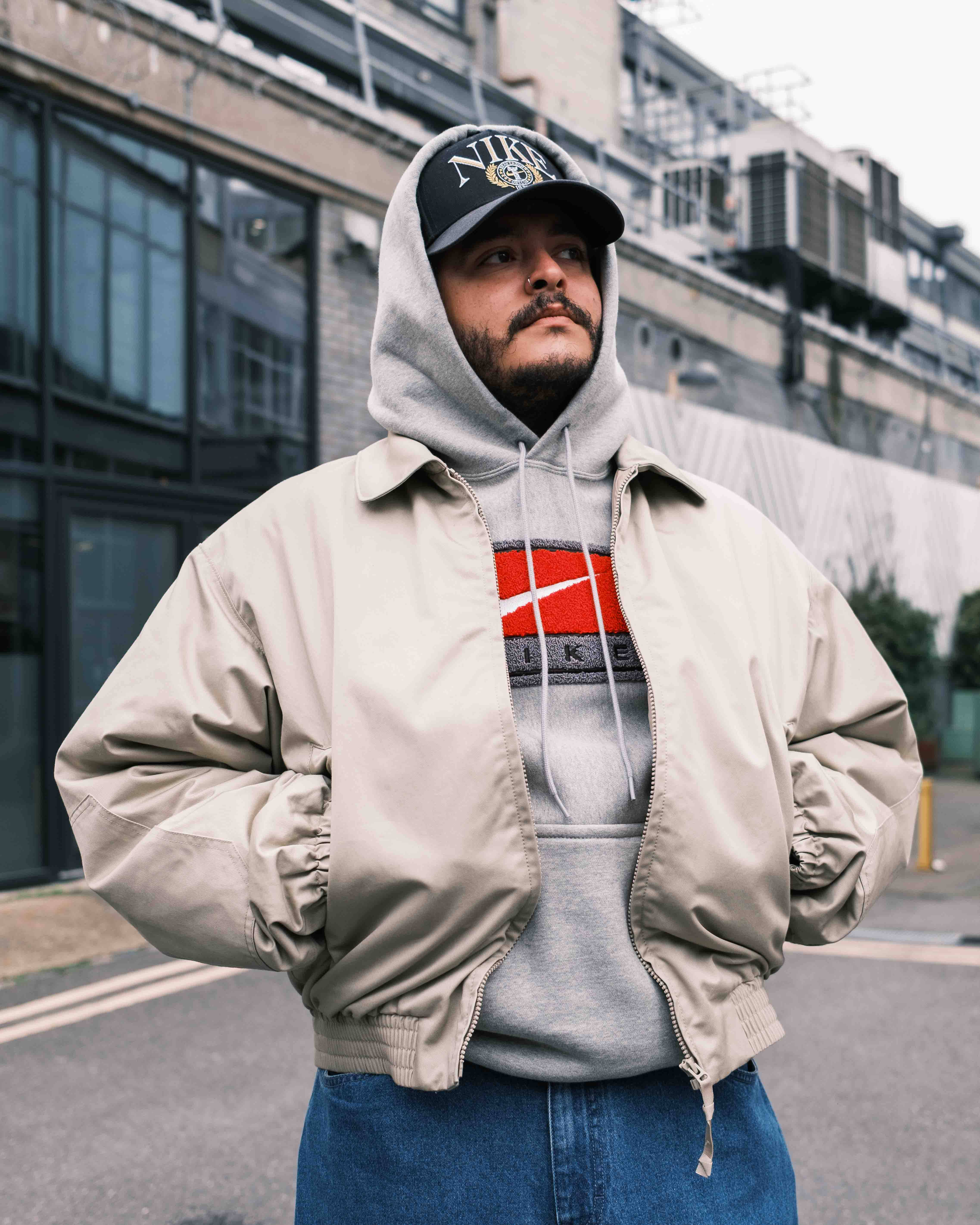 nike solo swoosh hoodie and cream bomber combination styled