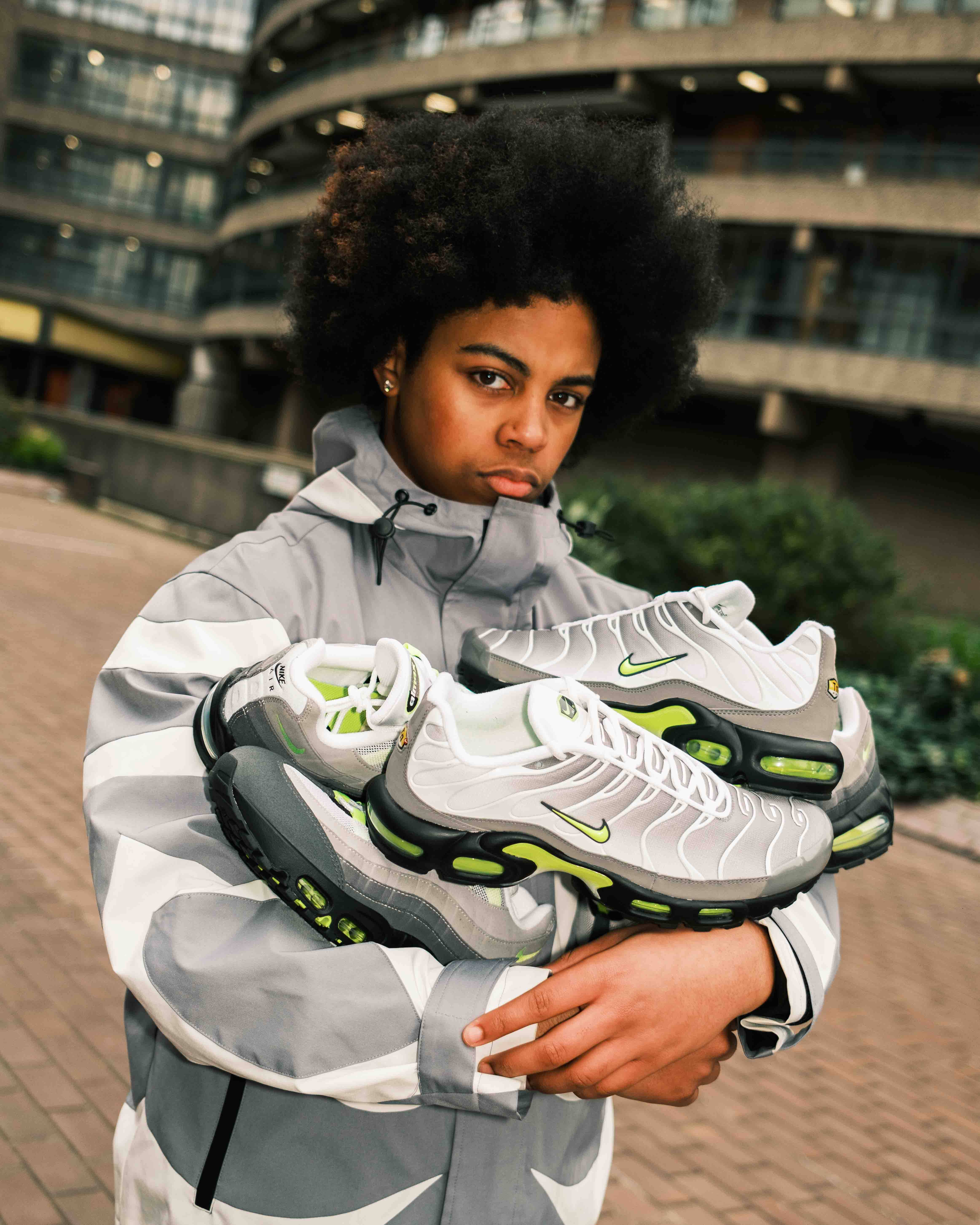 model holding the nike 2026 Neon collection with London backdrop