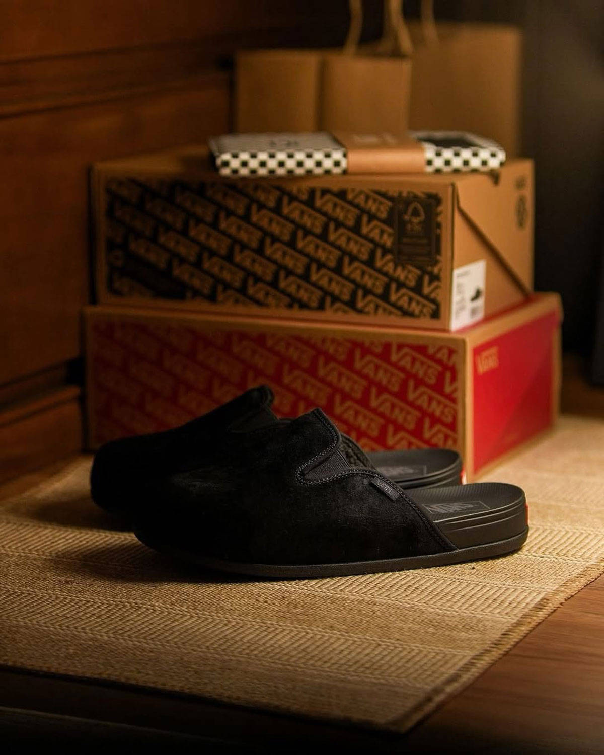 vans harbor mule slip-on editorial product shot on beige carpet and vans boxes in the backdrop
