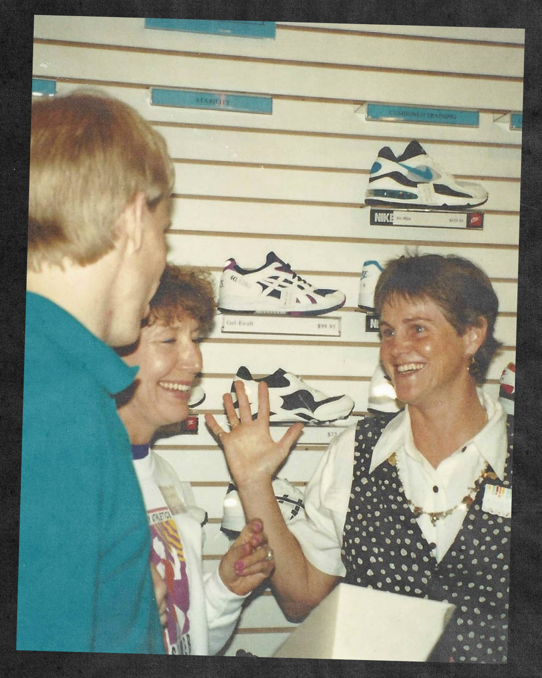 sports shop 1990s employee talking to customers with air max 93 in the background