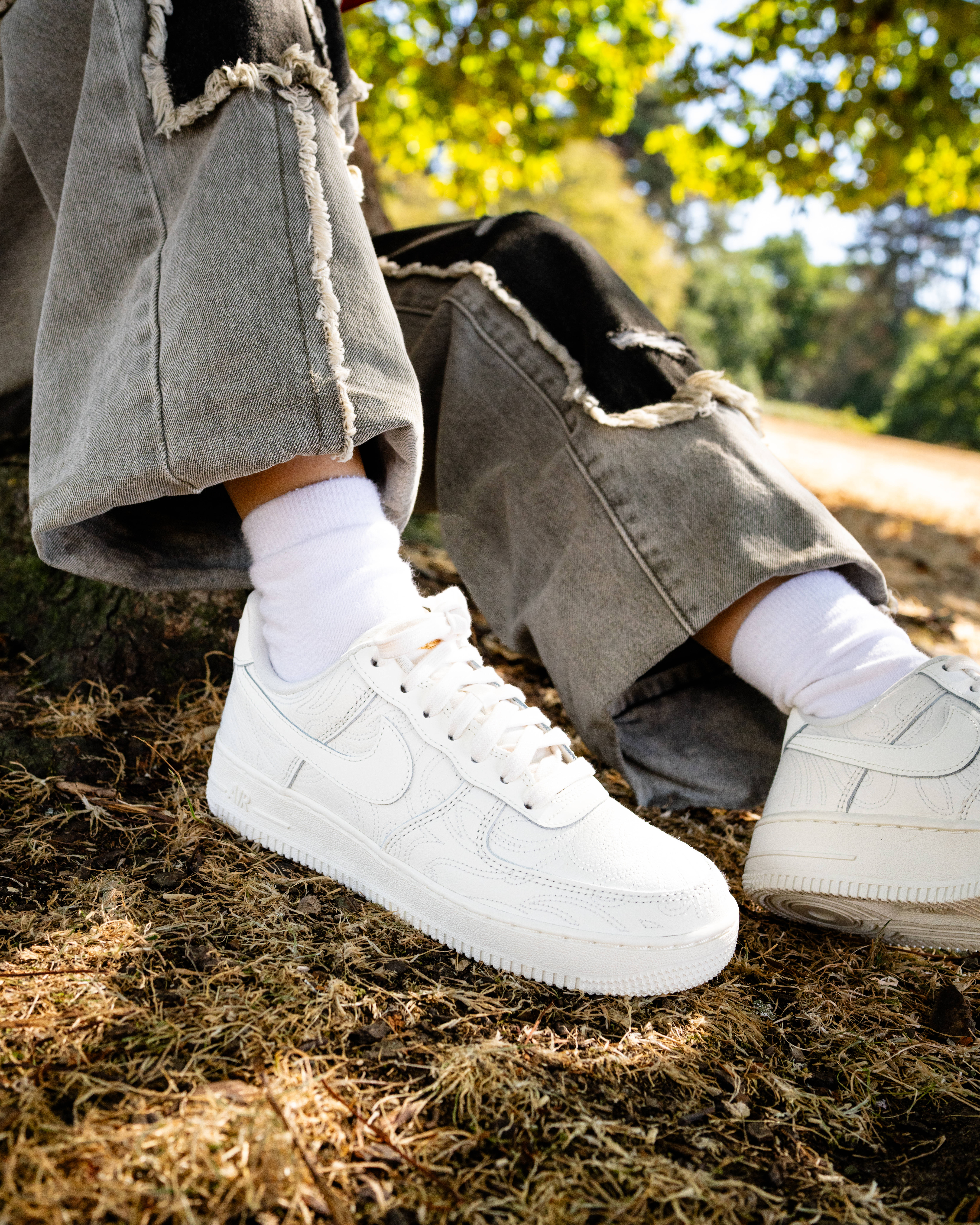 emilia poyiadgi air force 1 on feet with olive trouser forrest backdrop
