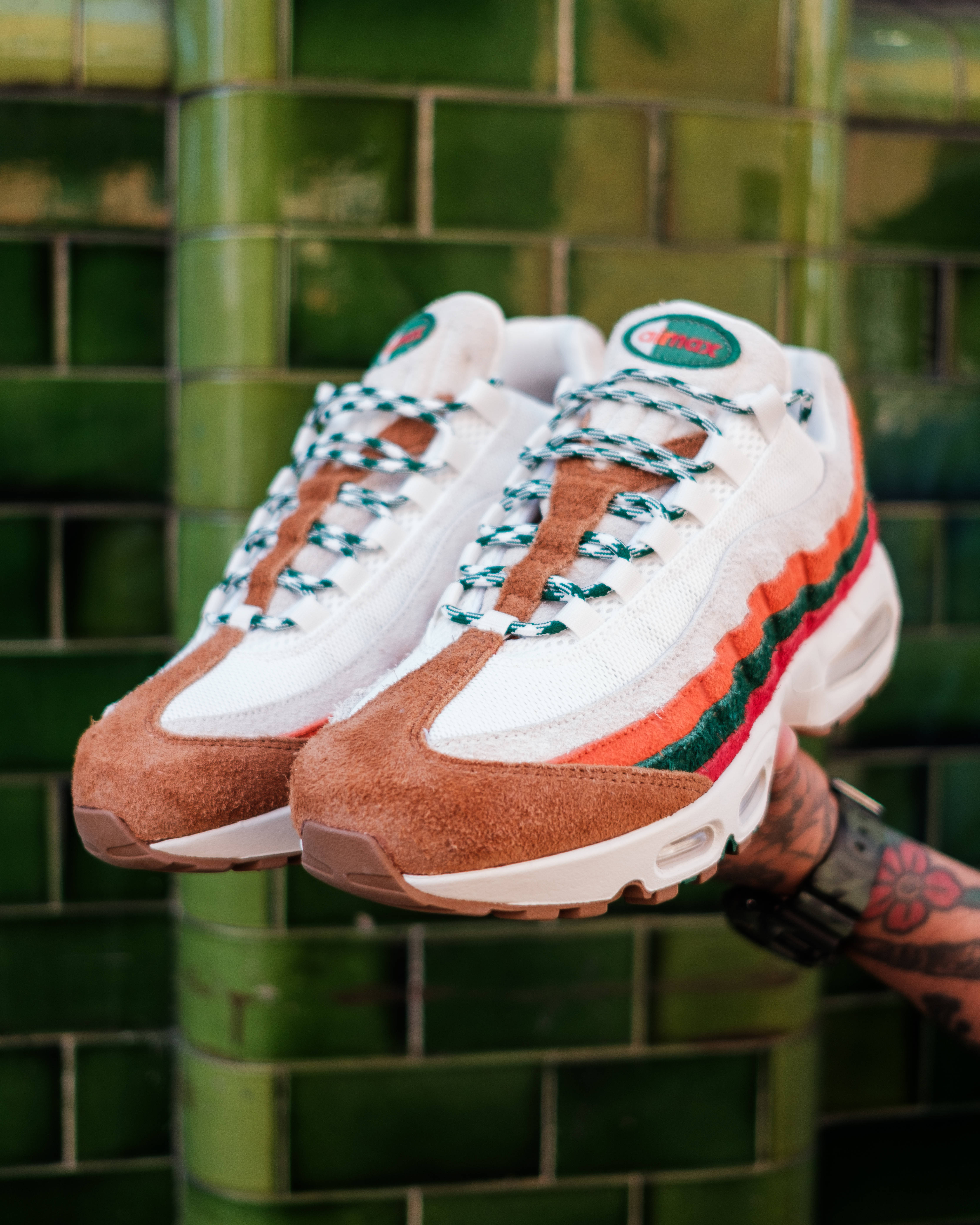 7-eleven nike air max 95 against green tiled background