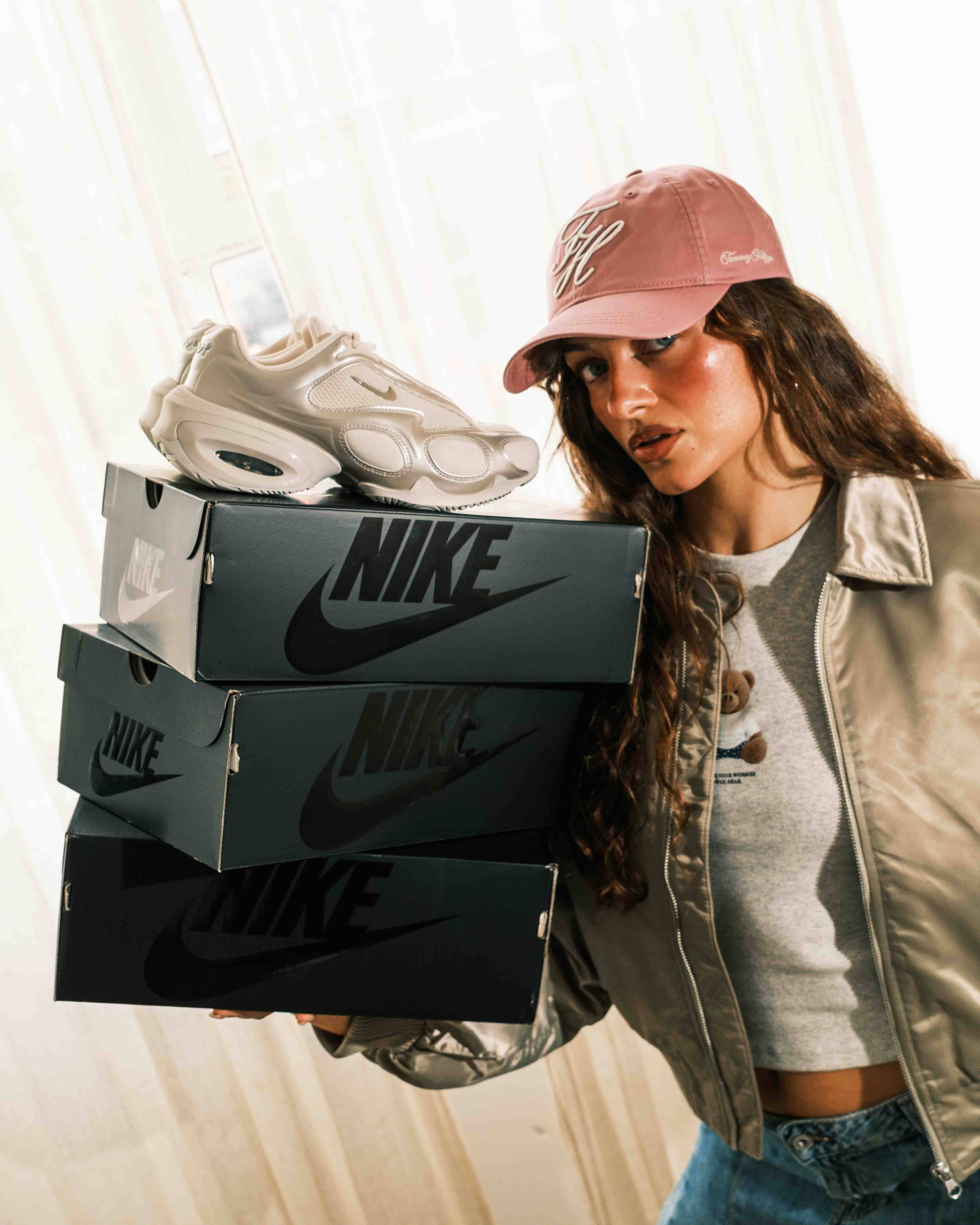 outfit 2 weekend full fit styled denim long skirt and bomber while model holds up boxes of nike air max muse