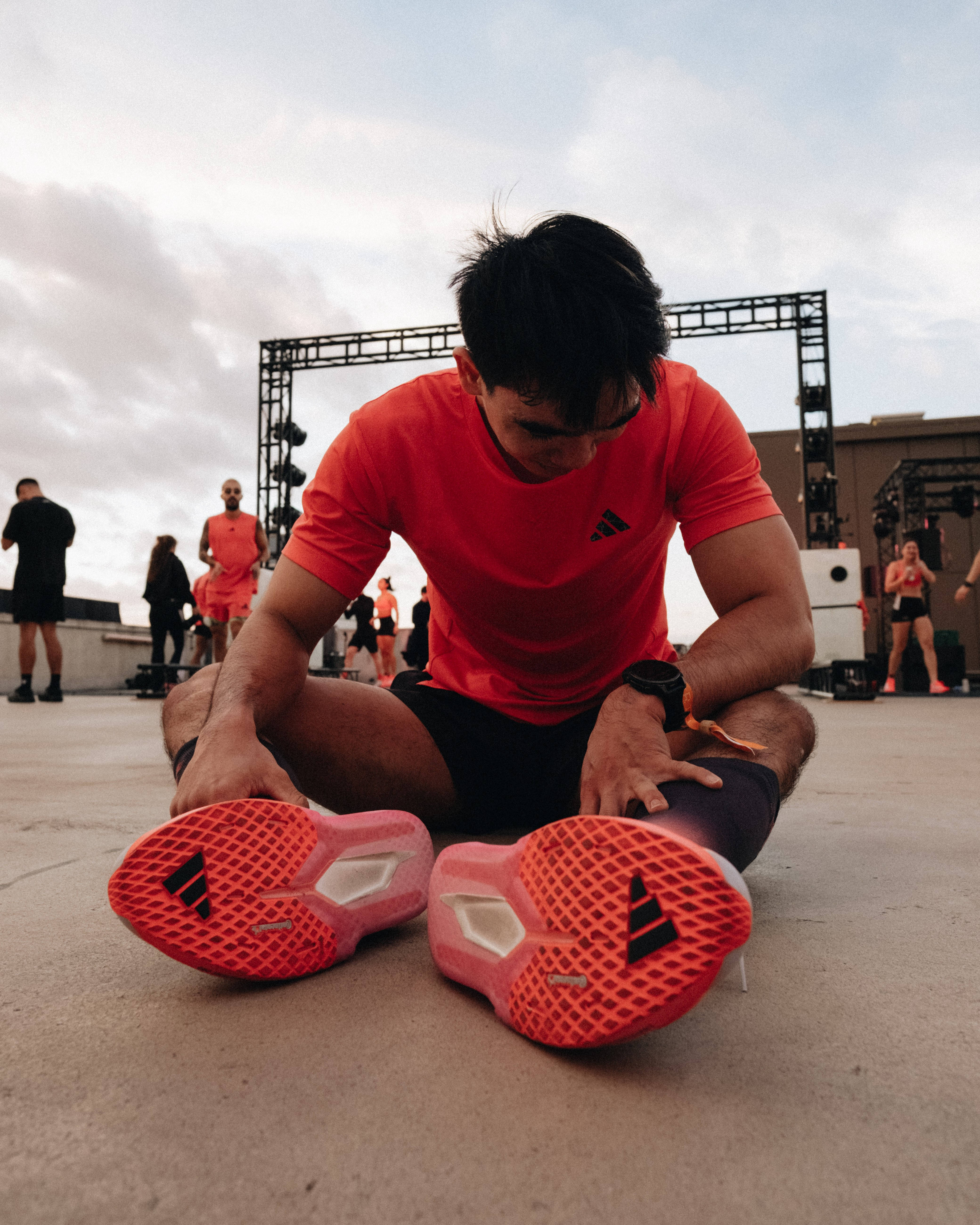 adidas hybrid athlete male resting checking watch sat down underneath shoes shot
