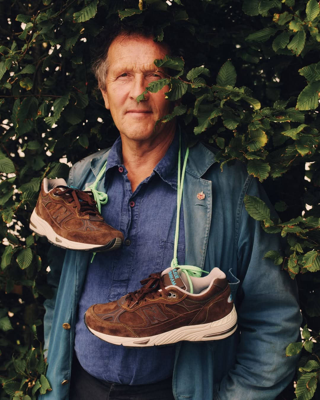 monty don next to bush with new balance shoes tied around his neck 