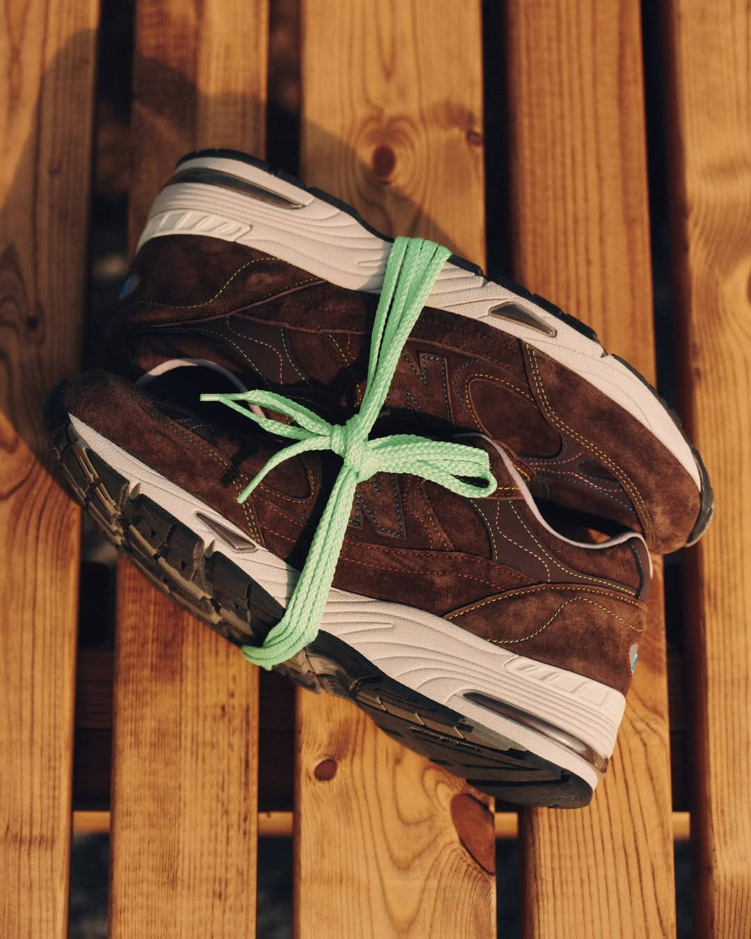 bleue burnham x new balance 991v1 tied together with green alternate lace
