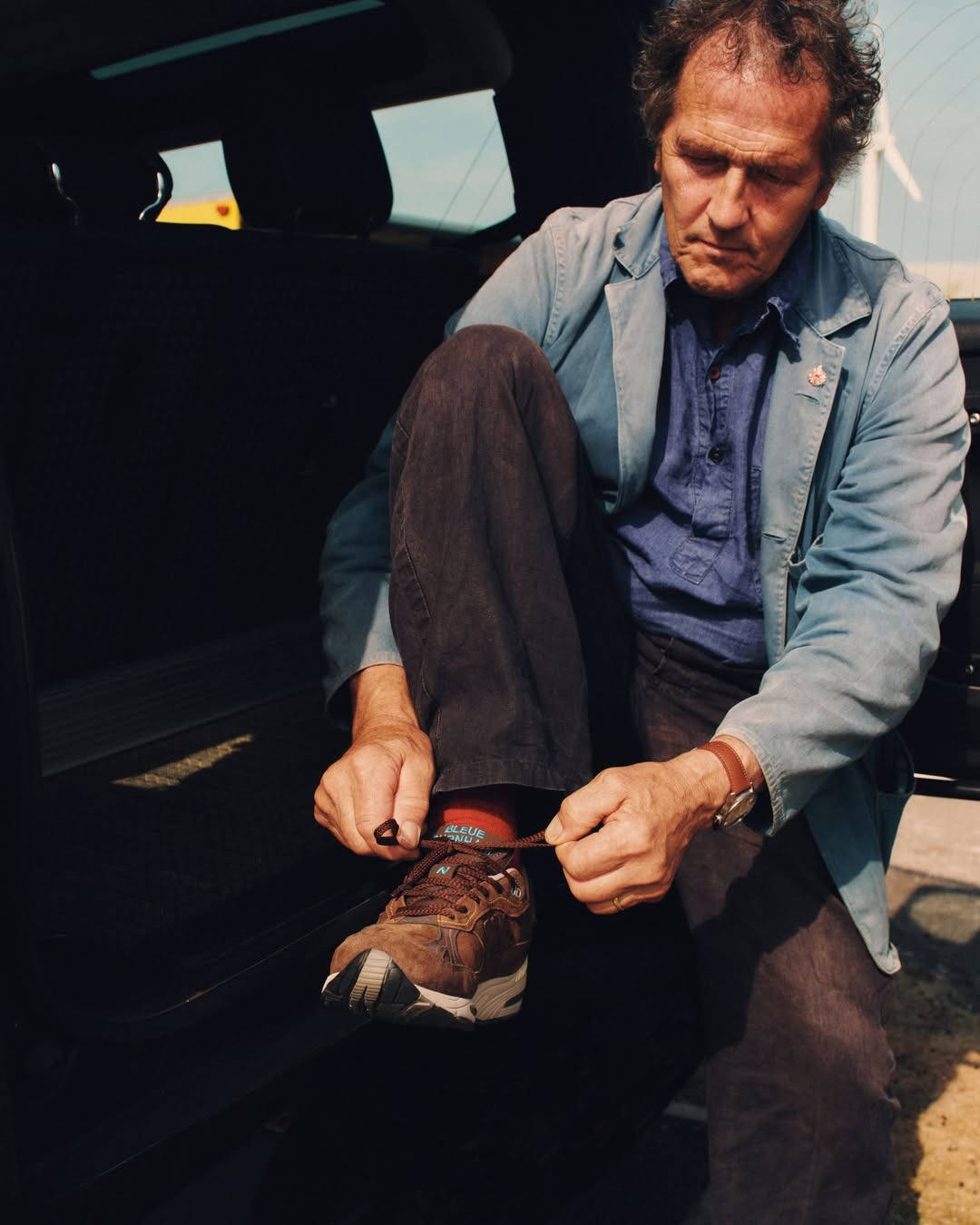 monty don styling new balance 991 collab editorial shot of model tying laces