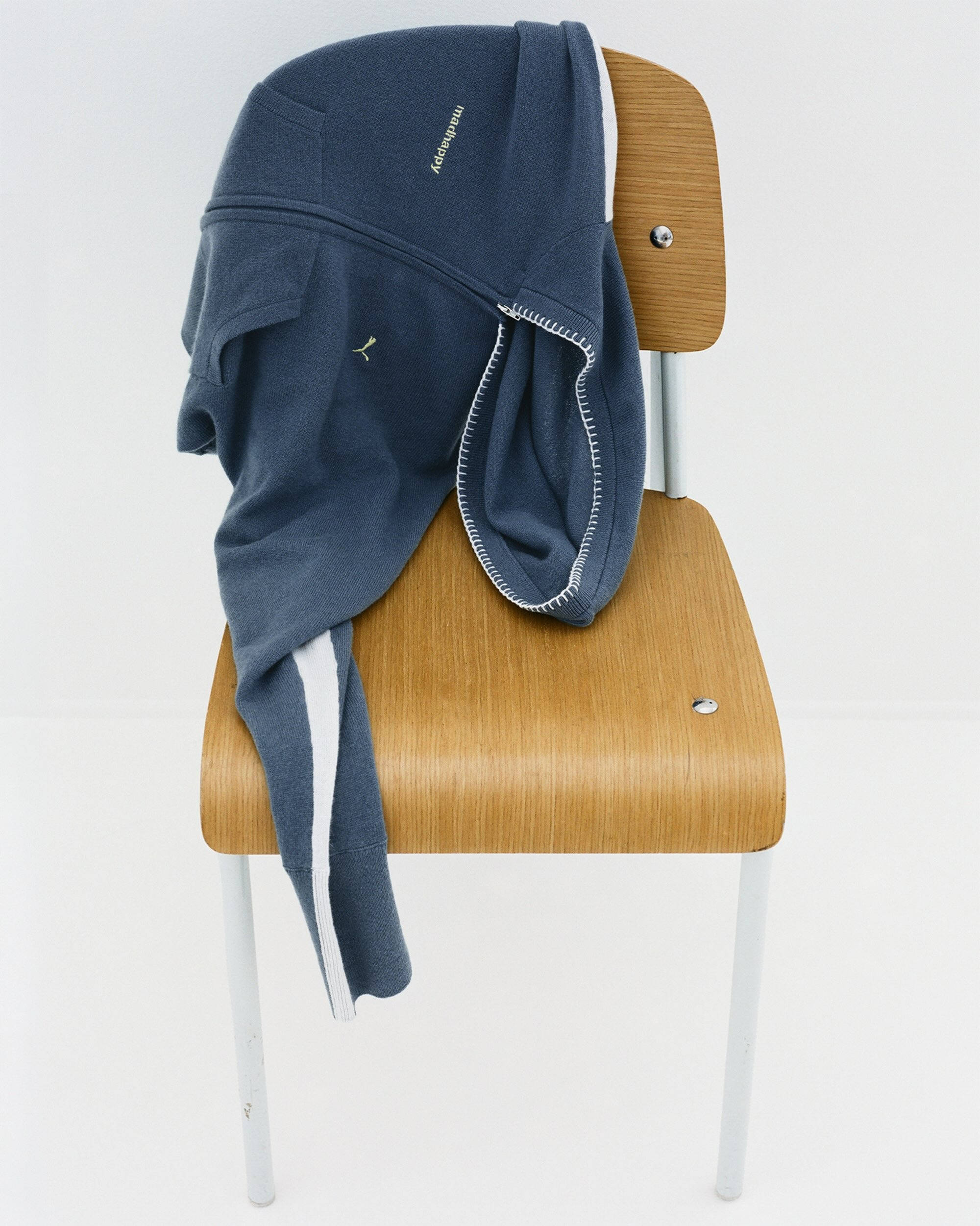 madhappy x puma hoodie draped over wooden chair