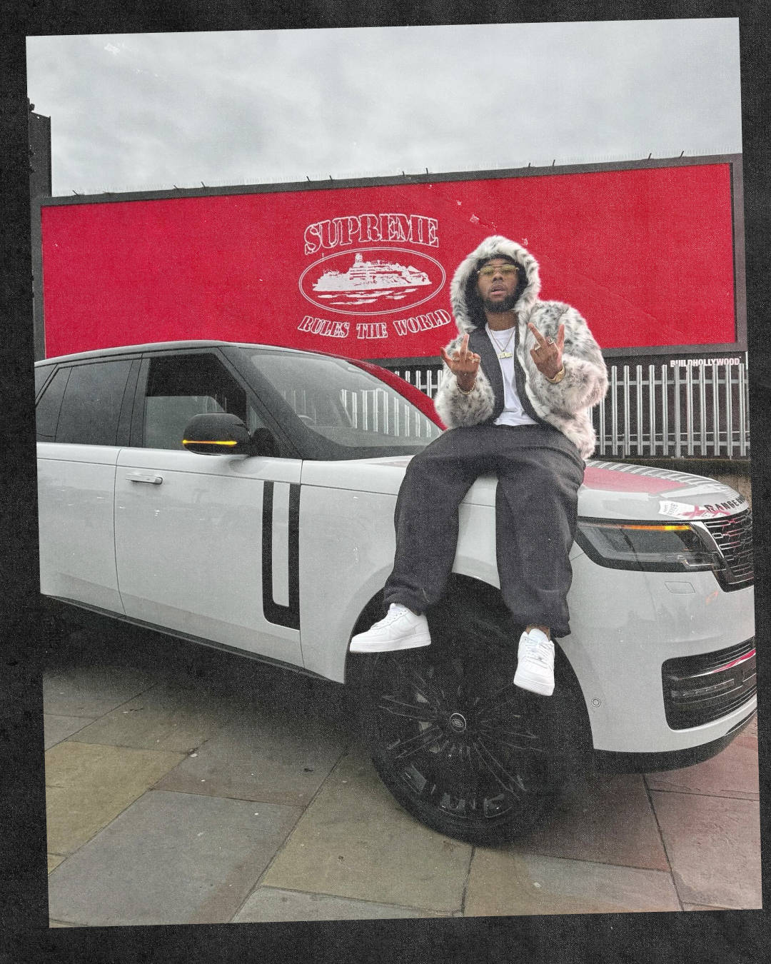 Clint419 sat on range rover wearing triple white air force 1